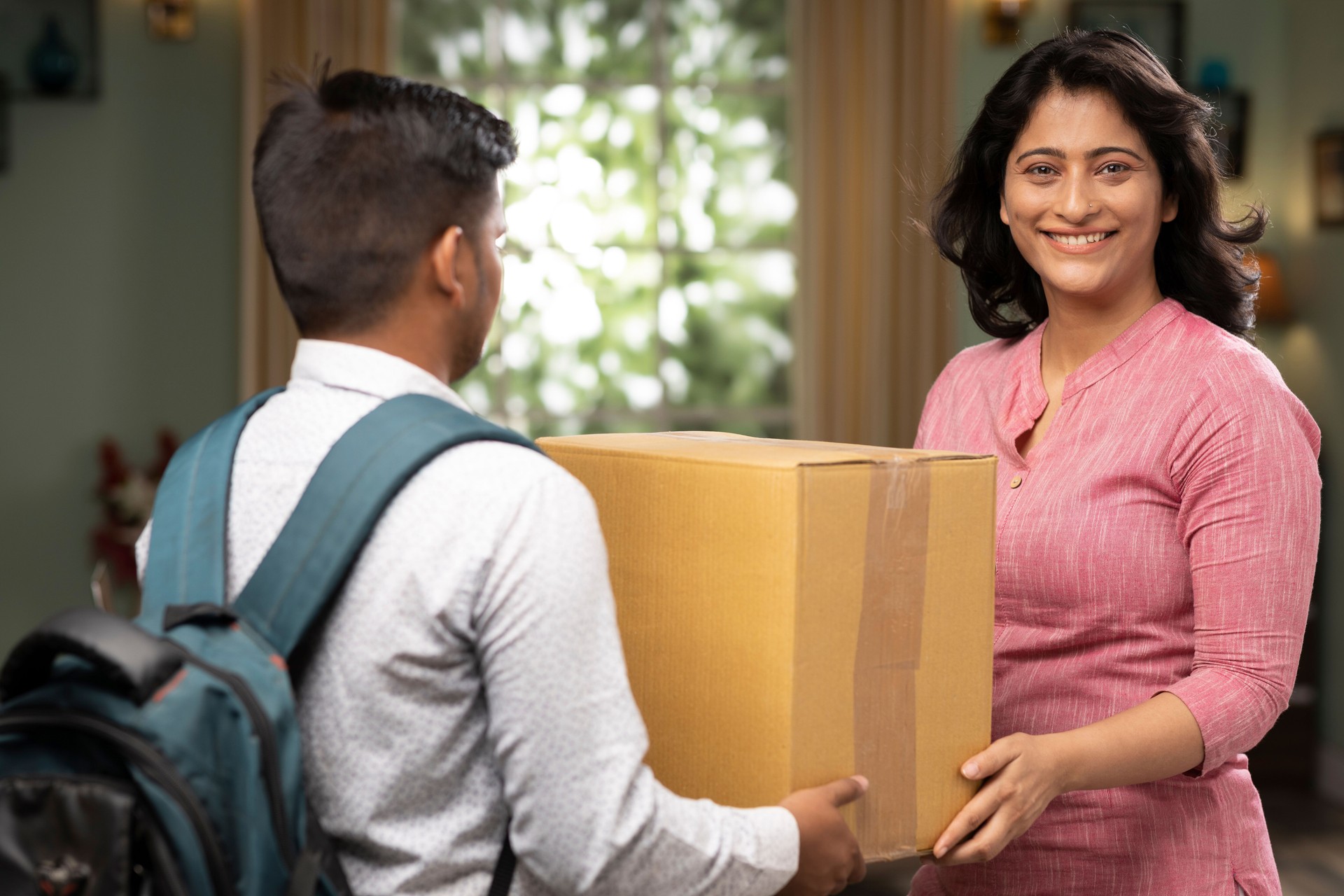 receiving a delivery from the mailman stock photo